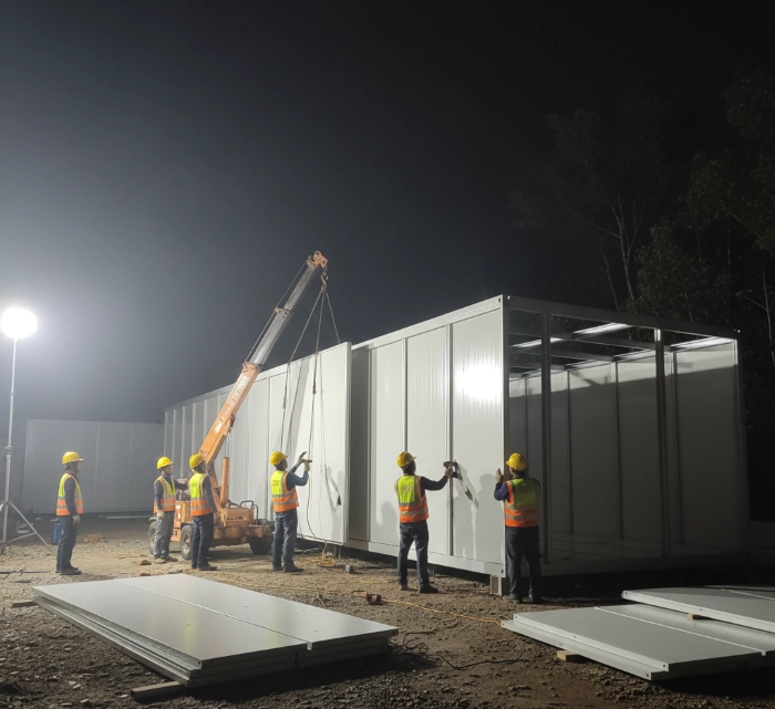 Installation of modular walls for accelerated employee mess construction.